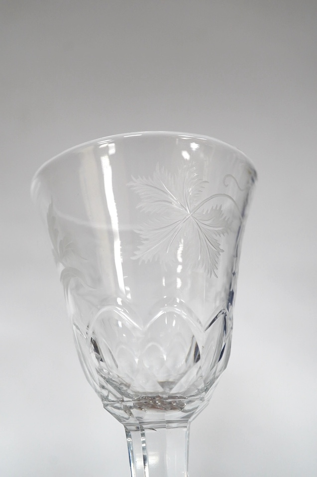A DSOT stem goblet, circa 1765, with a cup shaped bowl, diamond point engraved ‘J Edden’and a facet stem wine glass, circa 1770, the round funnel bowl engraved with fruiting vines a chrysanthemum and a moth, 15.3cm and 1